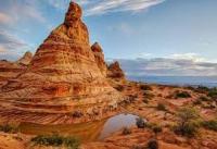 rust-colored pointed buttes with rust and beige striations