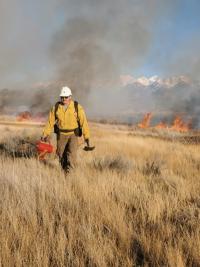 A BLM wildland firefighter conducts prescribed burn operations to help improve vital habitat for sensitive species in Colorado's San Luis Valley.