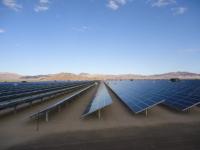 an array of long solar panels in the desert