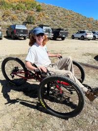 Photo of intern on adaptive bicycle at National Public Lands Day event