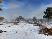 Fires billow smoke on a snow-covered landscape during a prescribed pile burn near Stinking Springs in the Whistler Mountains, north of Eureka, Nevada, Jan. 1, 2022.