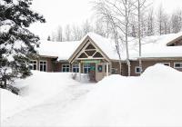 View of the front entrance to the BLM Campbell Creek Science Center Building surrounded by snow. 