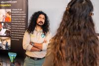 A man with long hair listens to a potential applicant