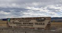 National Historic Trails Interpretive Center sign with cloudy sky in background. 