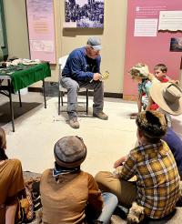 BLM archaeologist Patrick Walker gives a flint knapping demonstrations to Casper 4th graders. 