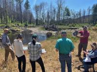 Members of the Western Oregon RAC listen to  BLM's fisheries biologist Jeff McEnroe explain fish habitat restoration after the Archie Creek Fire