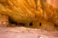 House on Fire, an archeological site within Bears Ears National Monument — a constructed stone structure, located in an alcove with distinct ribbons of sandstone creating a flame-like appearance. 