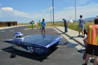 A solar car stops at the trails center during the american solar challenge. 