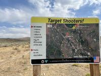 a shot up sign warning target shooters of hikers, mountain bikers, livestock and residences in area