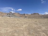 Photo 1: This photo shows a picture of the camping area in the foreground and the mountain bike free-ride area on the gray shale area in the background.