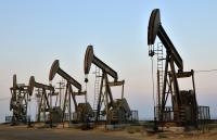 Five oil rigs on flat land.