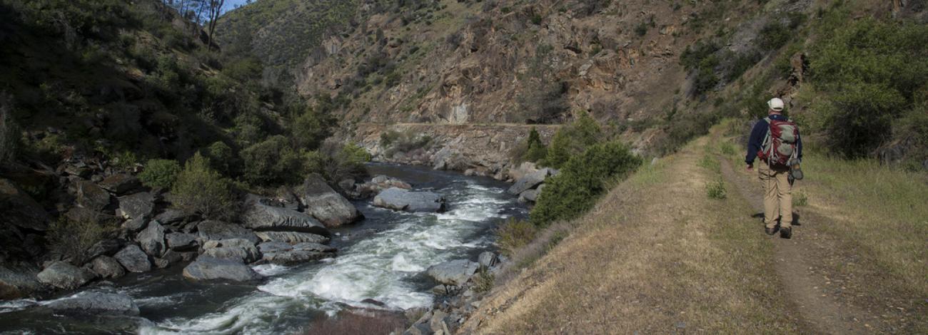 A hiker enjoys a trail through the foothills near the Merced River.  Photo by Bob Wick, BLM.